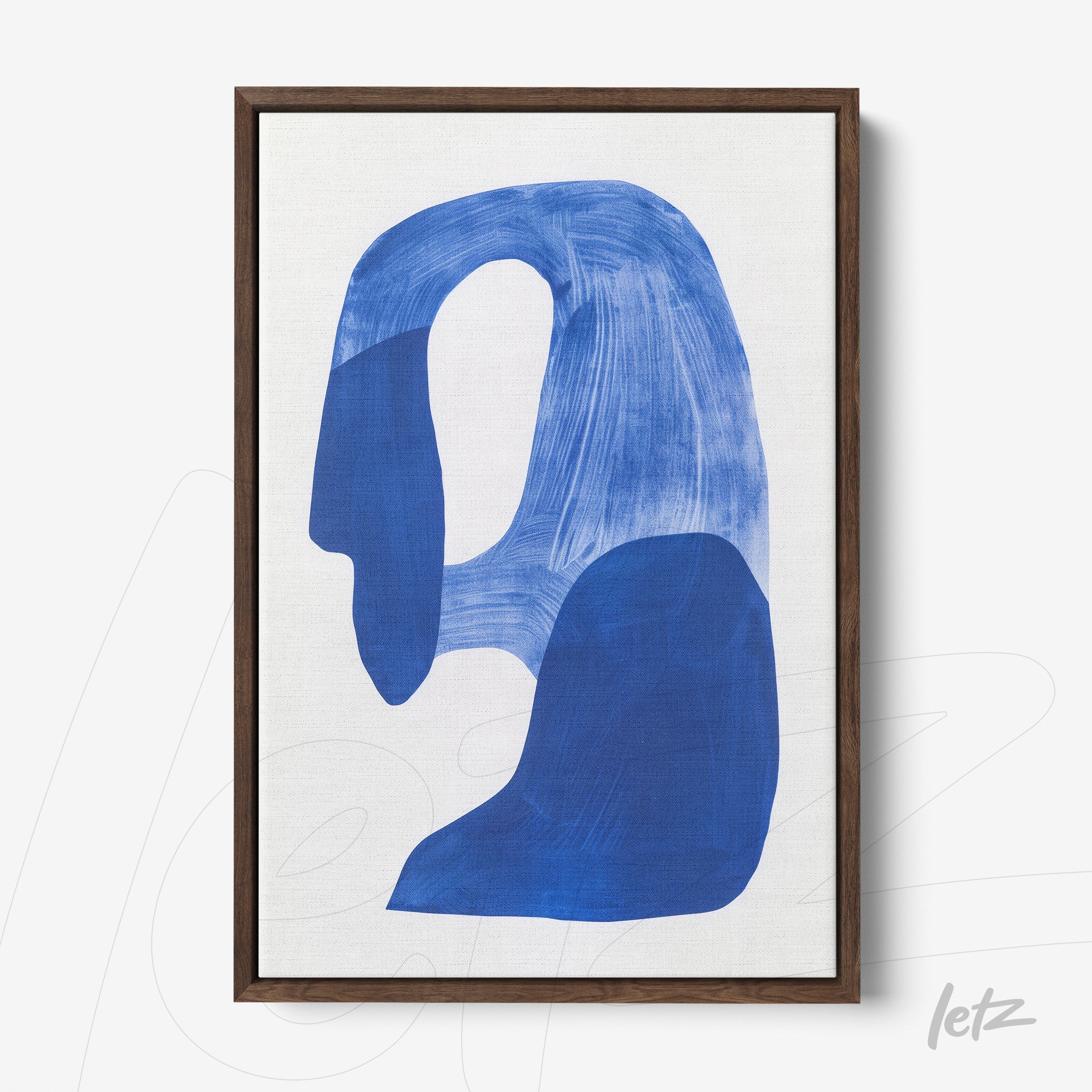 framed abstract art piece in blue on a light background with dark wood frame
