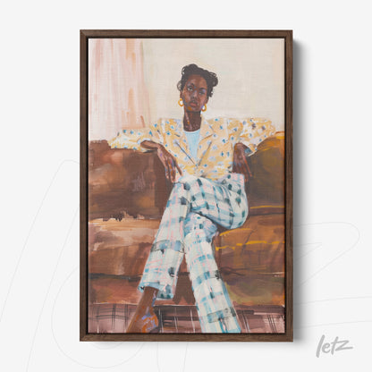 framed portrait of a woman sitting on a sofa, wearing a yellow floral shirt and checkered pants