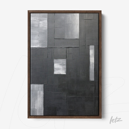 abstract wall art in shades of black and gray with textured surface, dark wood frame