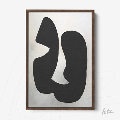 abstract wall art featuring black shapes on light background in dark wooden frame