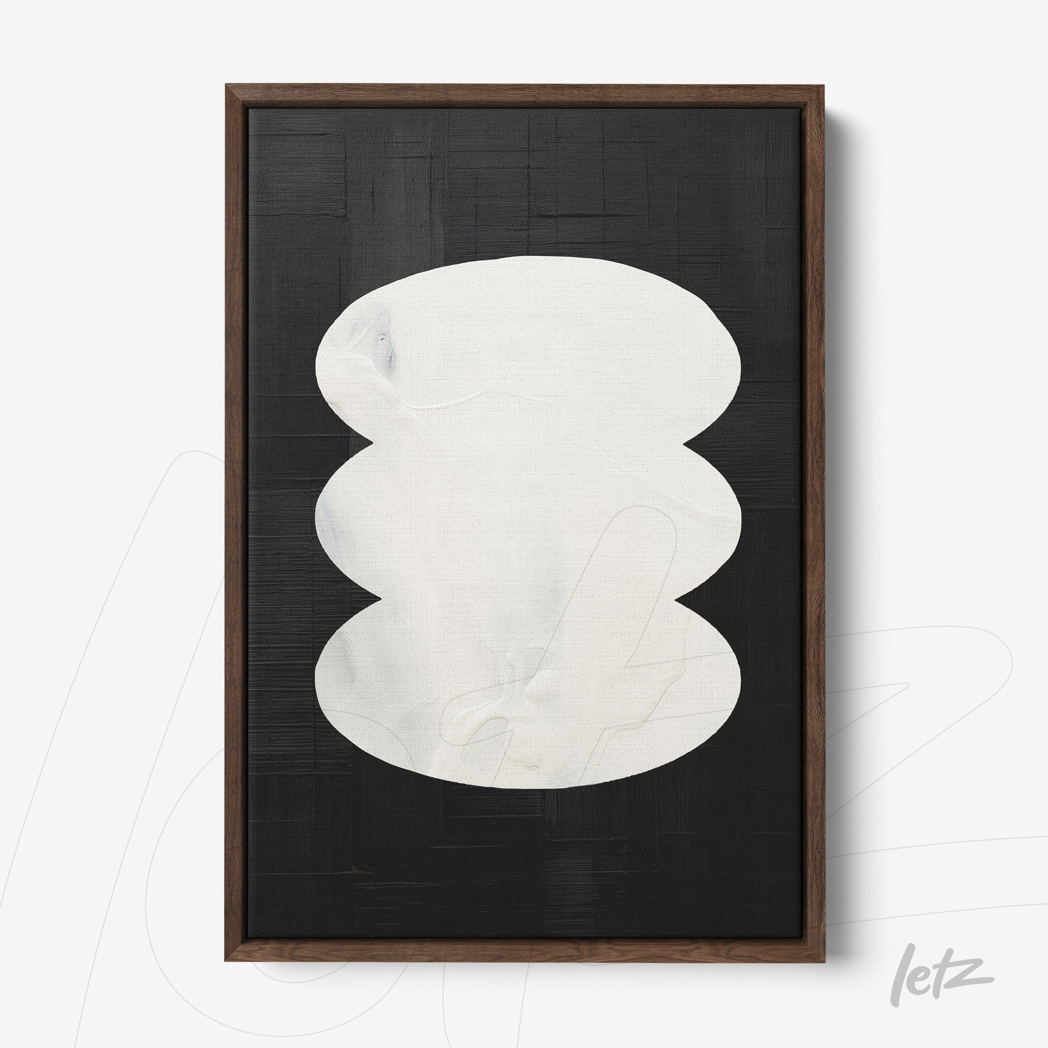 abstract wall art featuring white shapes on a black background with dark wooden frame