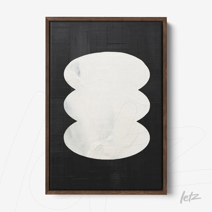 abstract wall art featuring white shapes on a black background with dark wooden frame