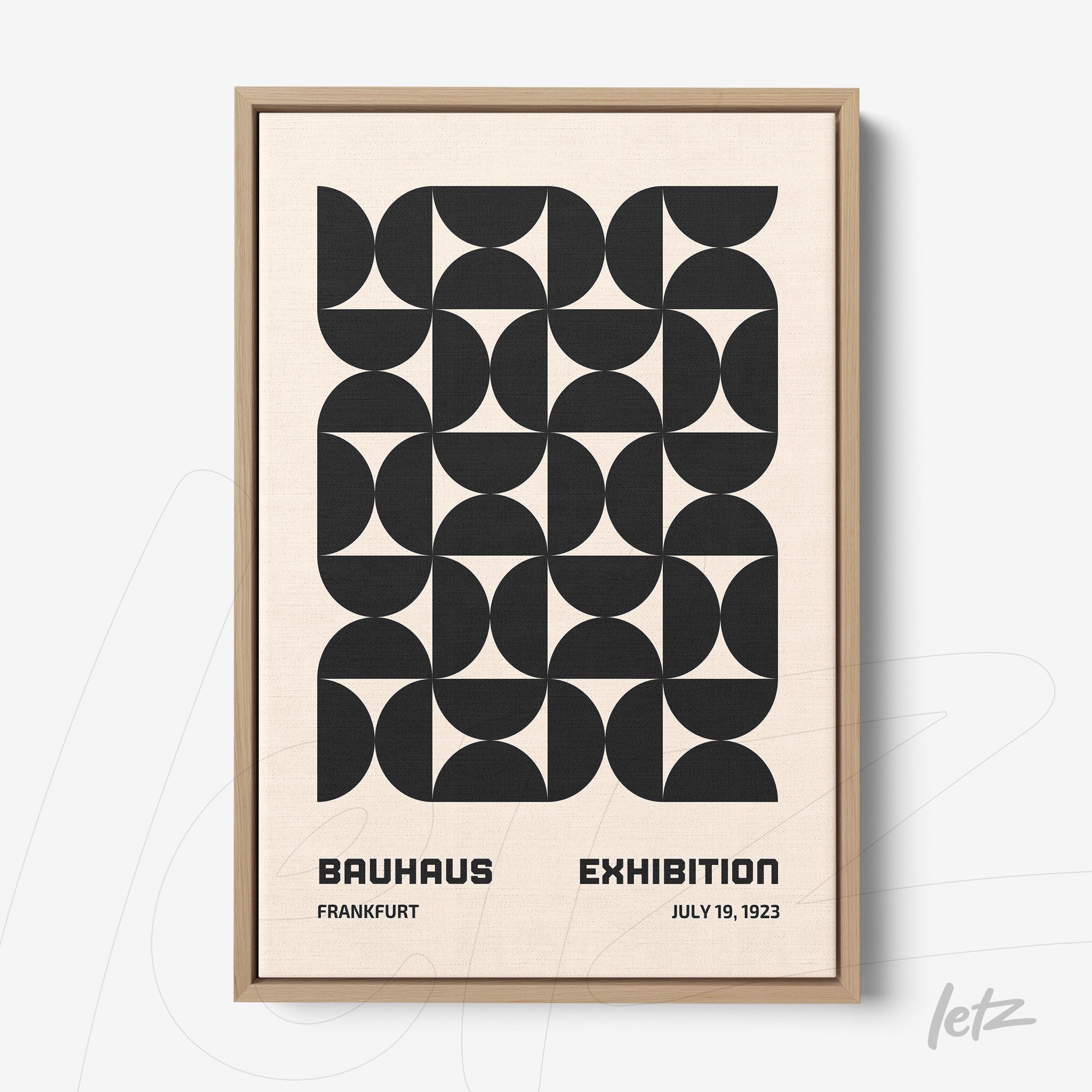framed wall art with black and white Bauhaus style geometric pattern in light wood frame
