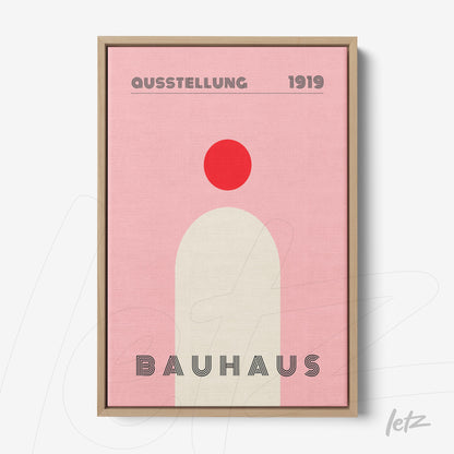 bauhaus style poster print with pink background and geometric shapes in light wood frame