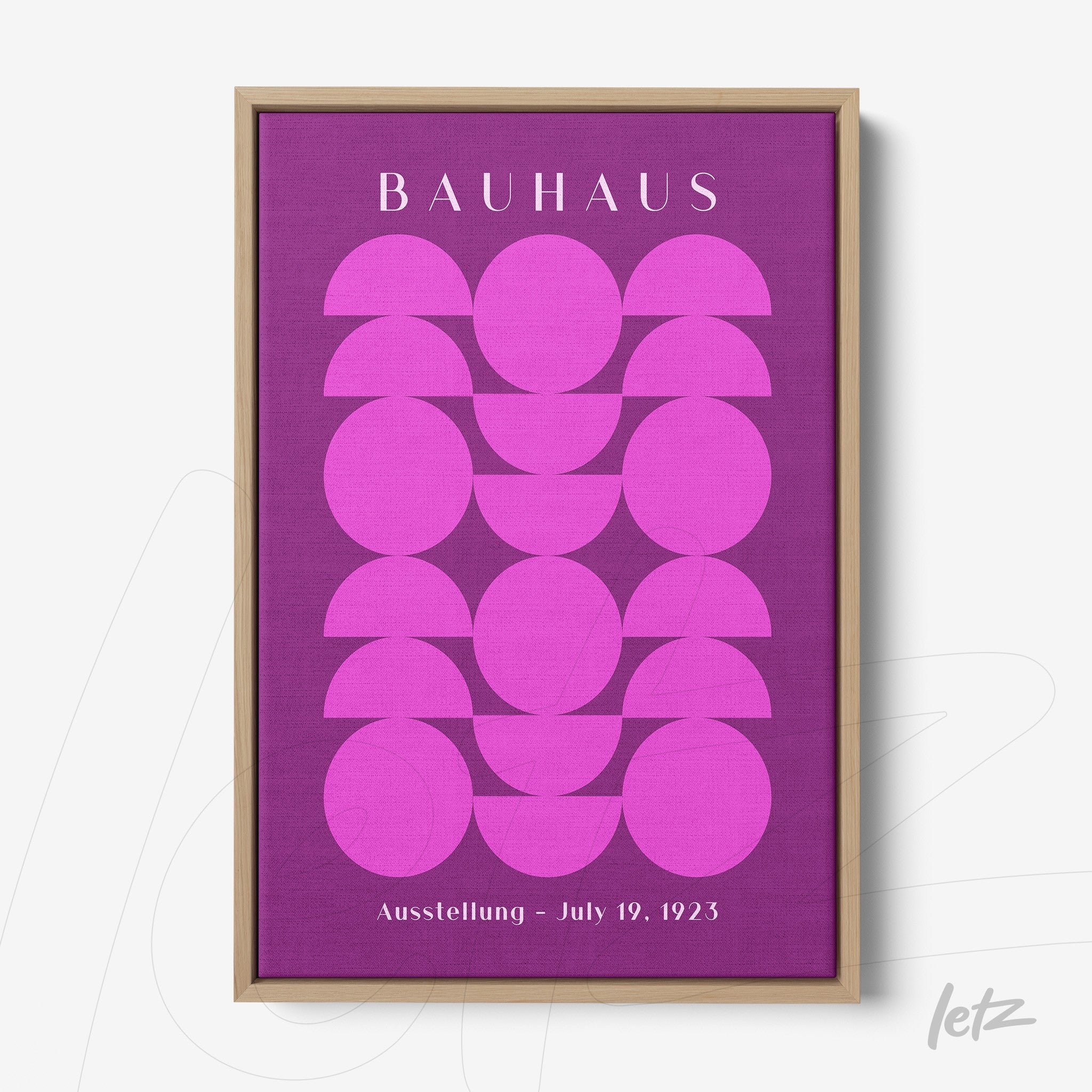 poster with geometric art of pink circles on a purple background with light wood frame