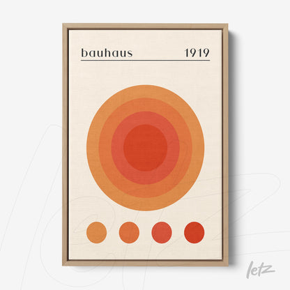 poster featuring concentric circles in orange and red hues within a light wooden frame