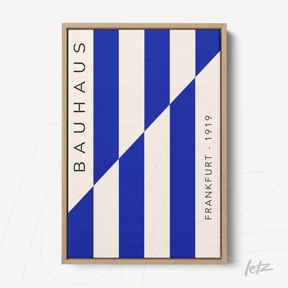 canvas print with geometric blue patterns and vertical text bauhaus frankfurt 1919 in light wood frame