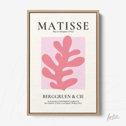 framed wall art featuring contemporary design with a pink leaf shape on a pink background and stylized text at the top