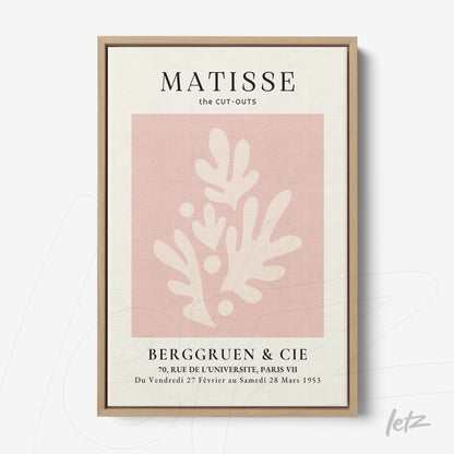 decorative framed art featuring a pink and cream cut-out illustration inspired by Matisse, with a light wood frame