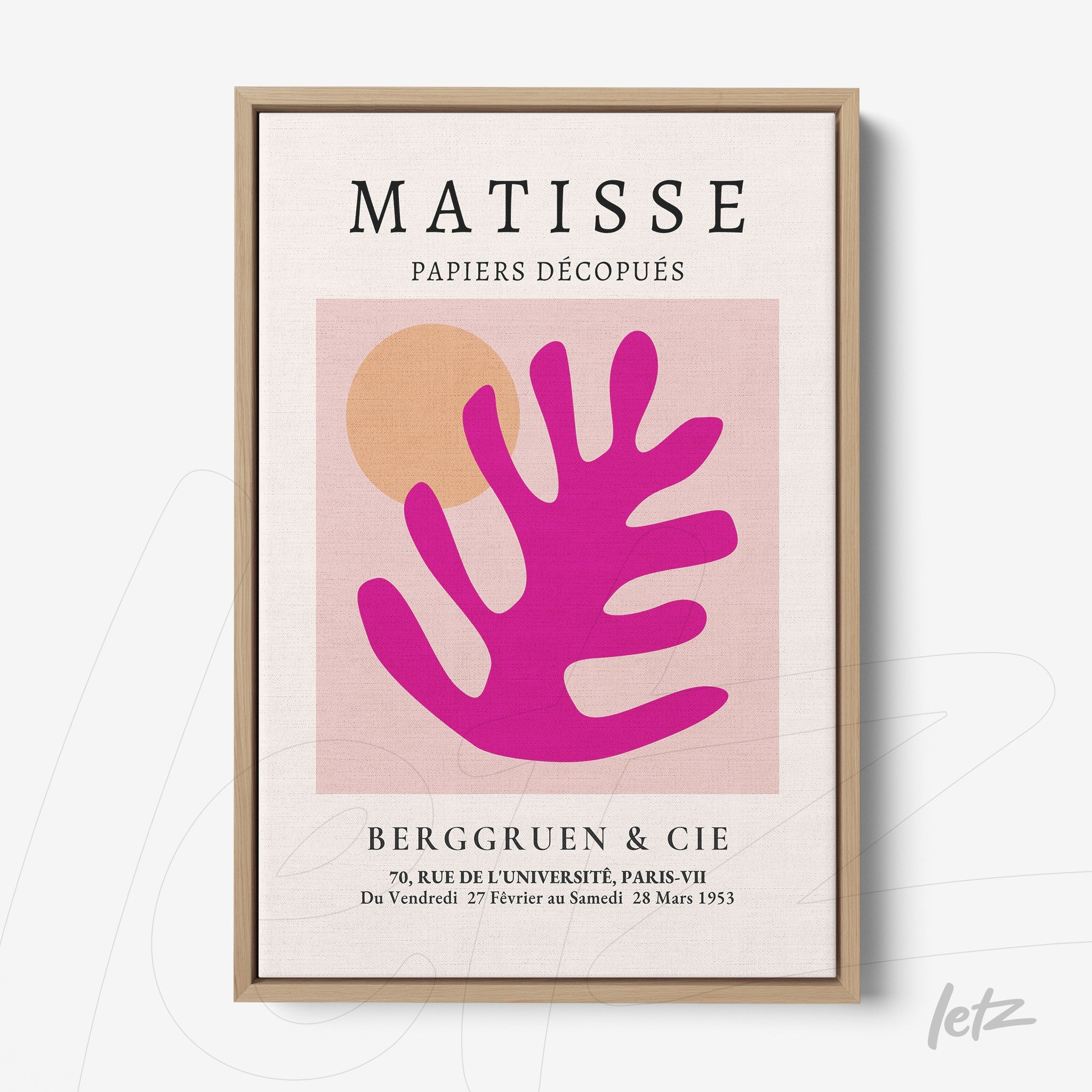framed modern art featuring a stylized leaf in shades of pink and orange with a light wood frame