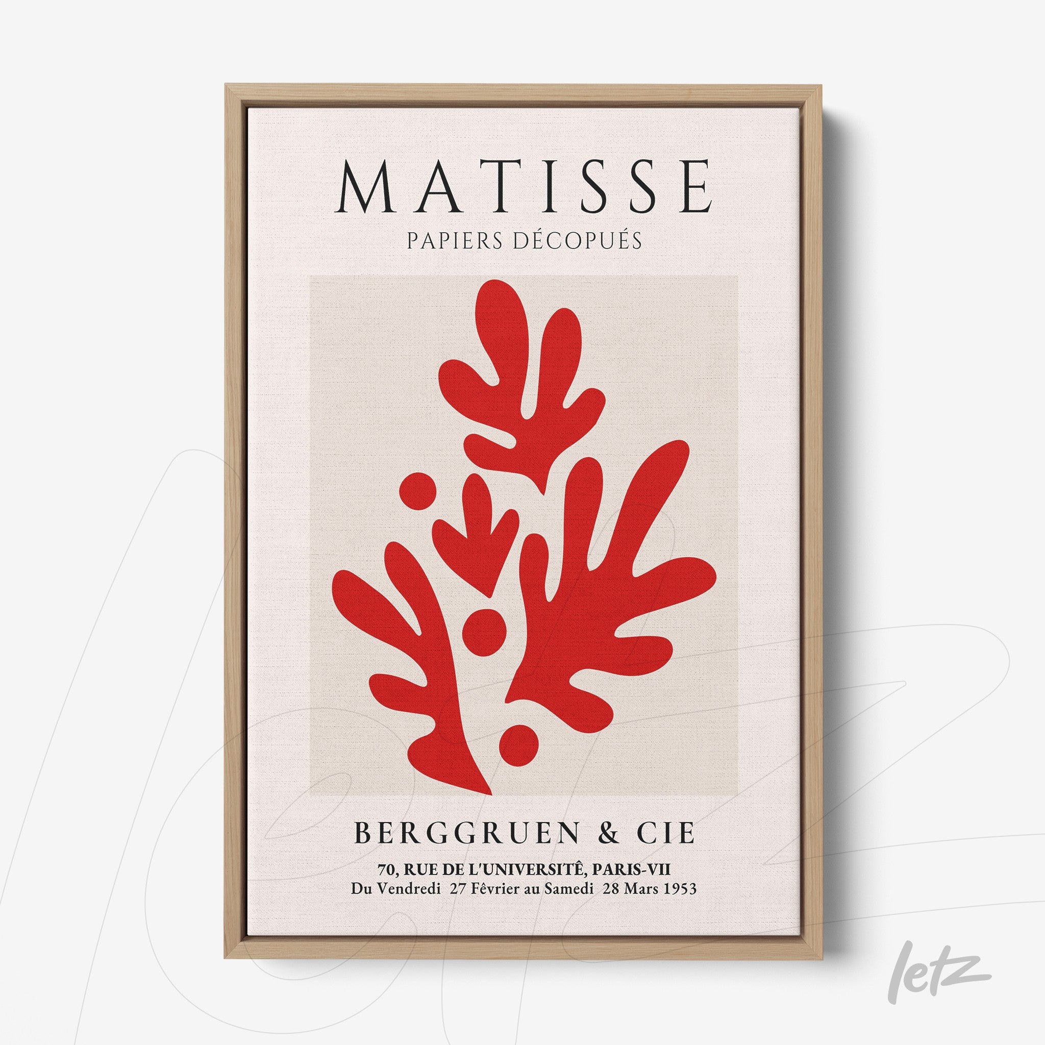 framed artwork featuring red cut-out shapes inspired by Matisse with light wood frame
