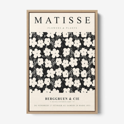 vintage style framed artwork featuring white flowers on black background with light wood frame