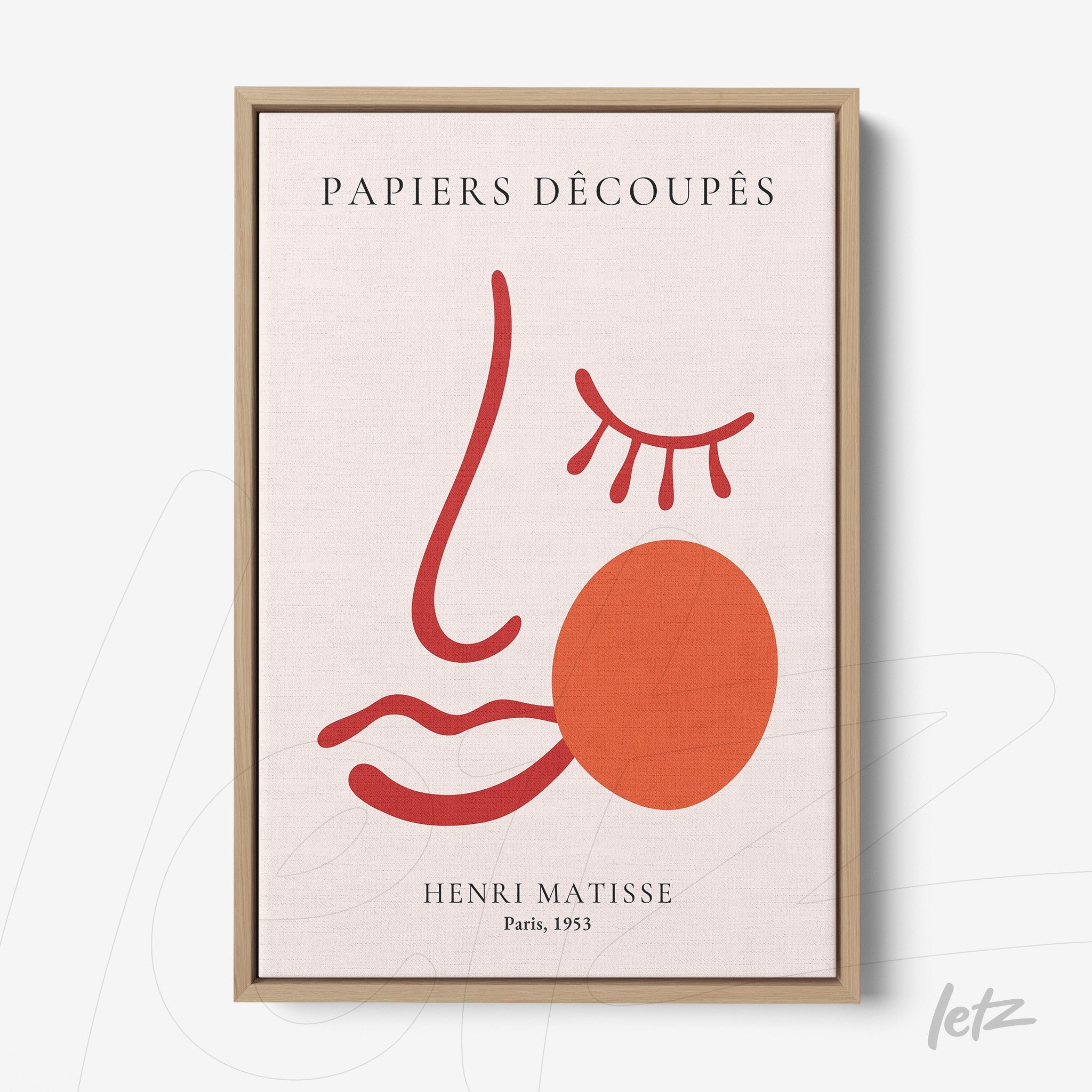 framed modern art print featuring a stylized face in red and pink tones with a light wood frame