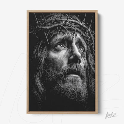framed artwork depicting the face of Christ wearing a crown of thorns with light wood frame