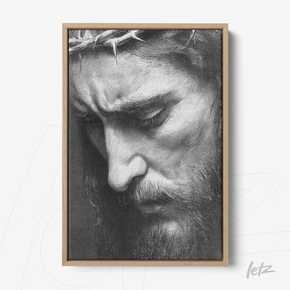 framed artwork in black and white of a man's face with a crown of thorns in light wood frame