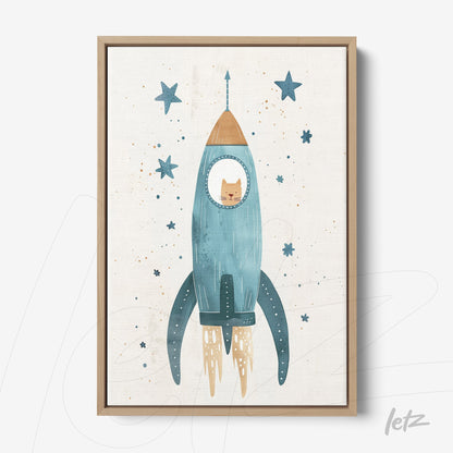 framed artwork featuring a blue rocket with a cat inside, decorated with stars on a light background, light wood frame