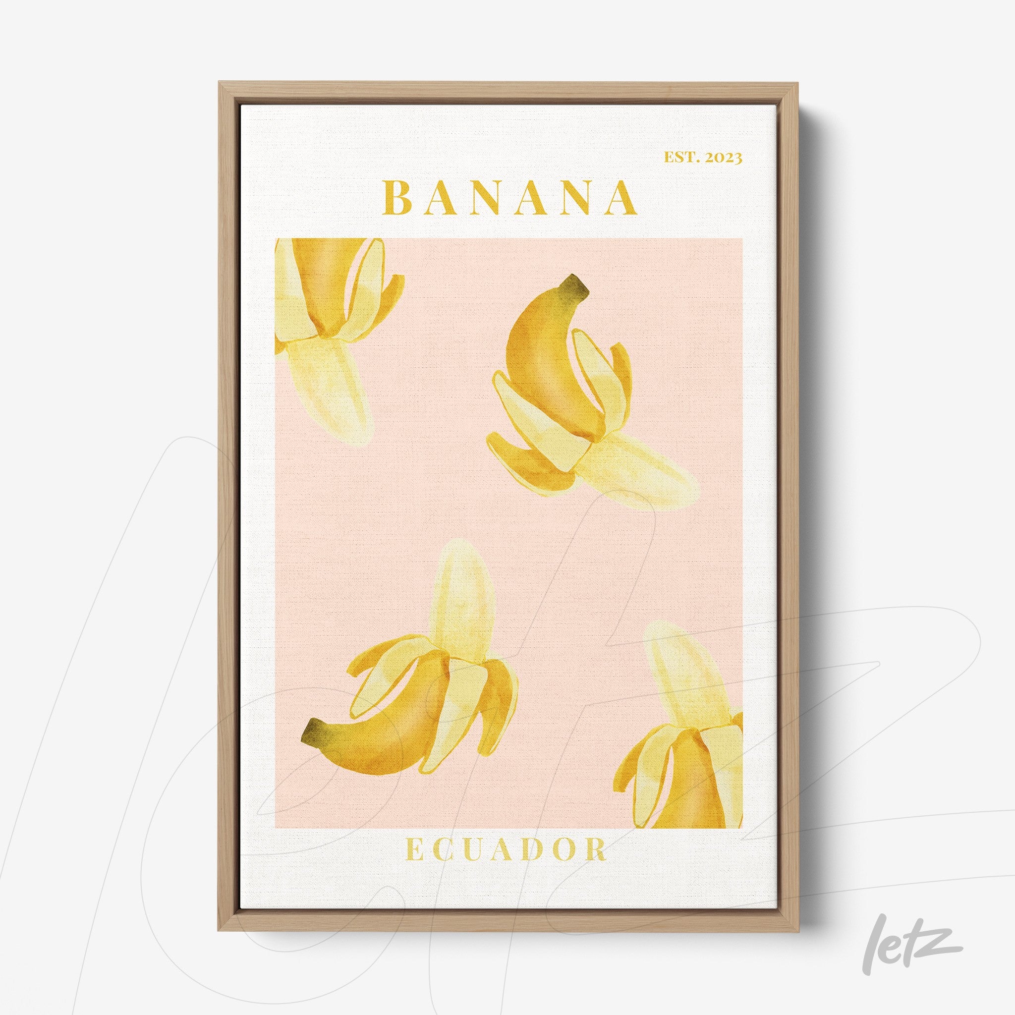 framed wall art featuring bananas on a pink background with yellow text
