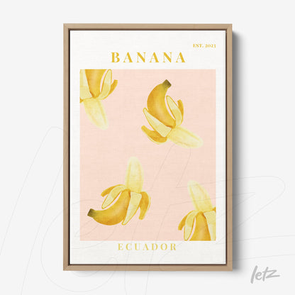framed wall art featuring bananas on a pink background with yellow text