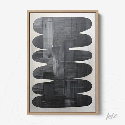 abstract canvas art featuring oval shapes in black on a light background, framed in light wood