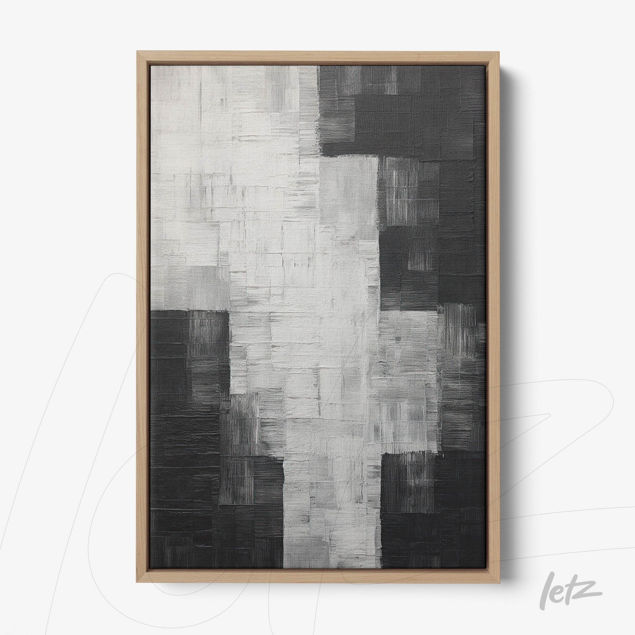 canvas print featuring abstract art in shades of black, white, and gray with a light wood frame