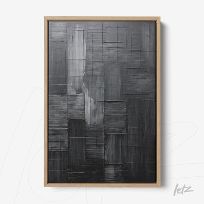 abstract wall art in black tones featuring textured design with light wood frame
