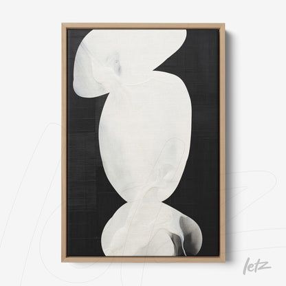 abstract wall art in shades of white on a black background with a light wood frame