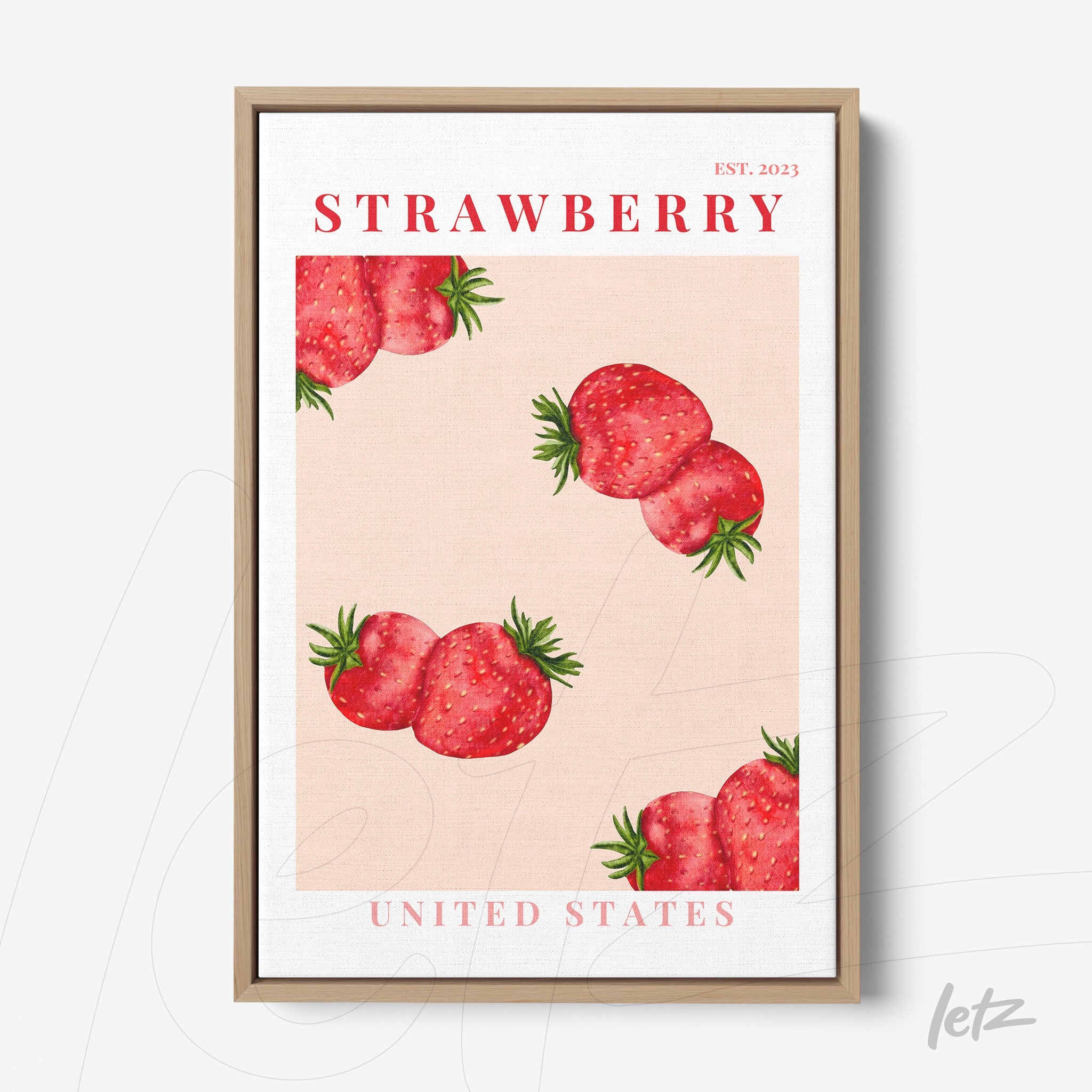 framed artwork featuring red strawberries on a light pink background with a light wood frame