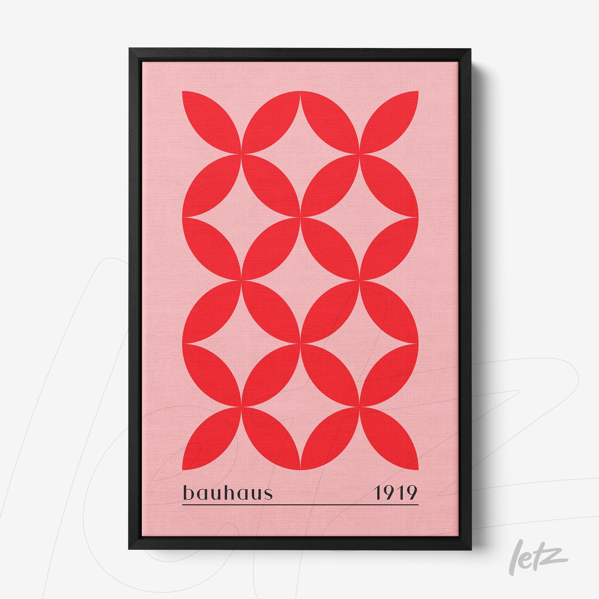 geometric art print in red on pink background with 'bauhaus 1919' text in black frame