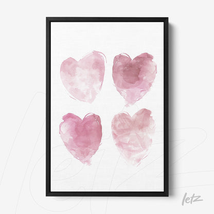 framed watercolor art featuring four pink hearts in black frame