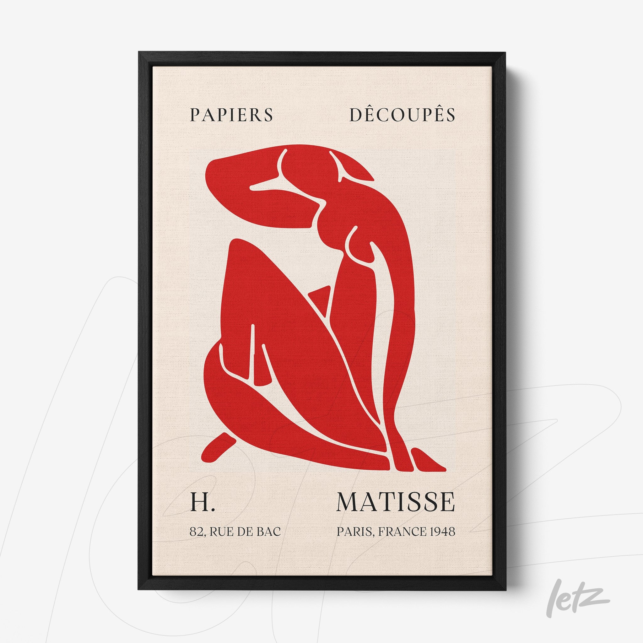 framed artwork featuring a red cut-out illustration of a female figure in a contemplative pose, with black frame and light-colored background including French text
