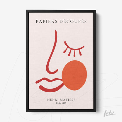 framed abstract art piece featuring a minimalist face in red tones on a light background