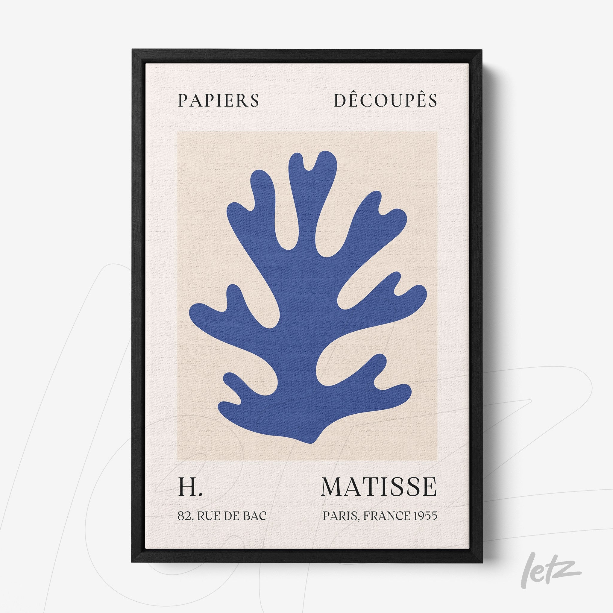 framed abstract art featuring a blue plant shape against a light background