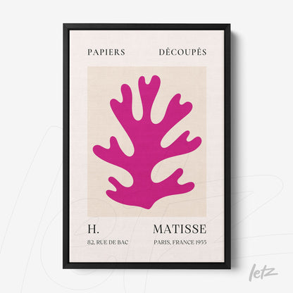 framed artwork featuring colorful cutouts in pink on a light background with a thin black frame