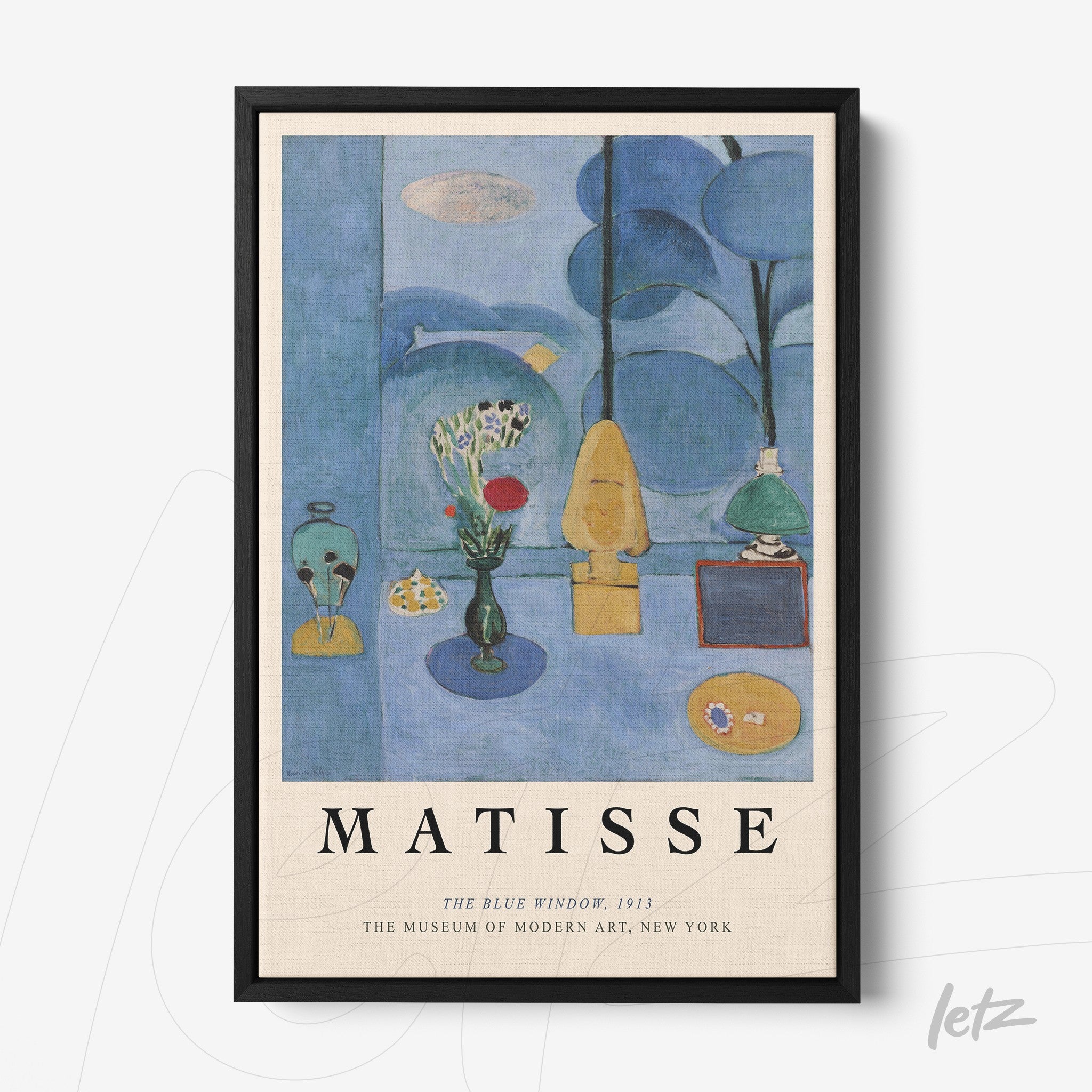 framed modern art by Matisse depicting a blue interior with decorative elements like vases and a lamp