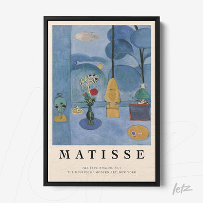 framed modern art by Matisse depicting a blue interior with decorative elements like vases and a lamp