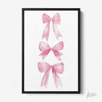 framed wall art with watercolor illustrations of pink bows in black frame