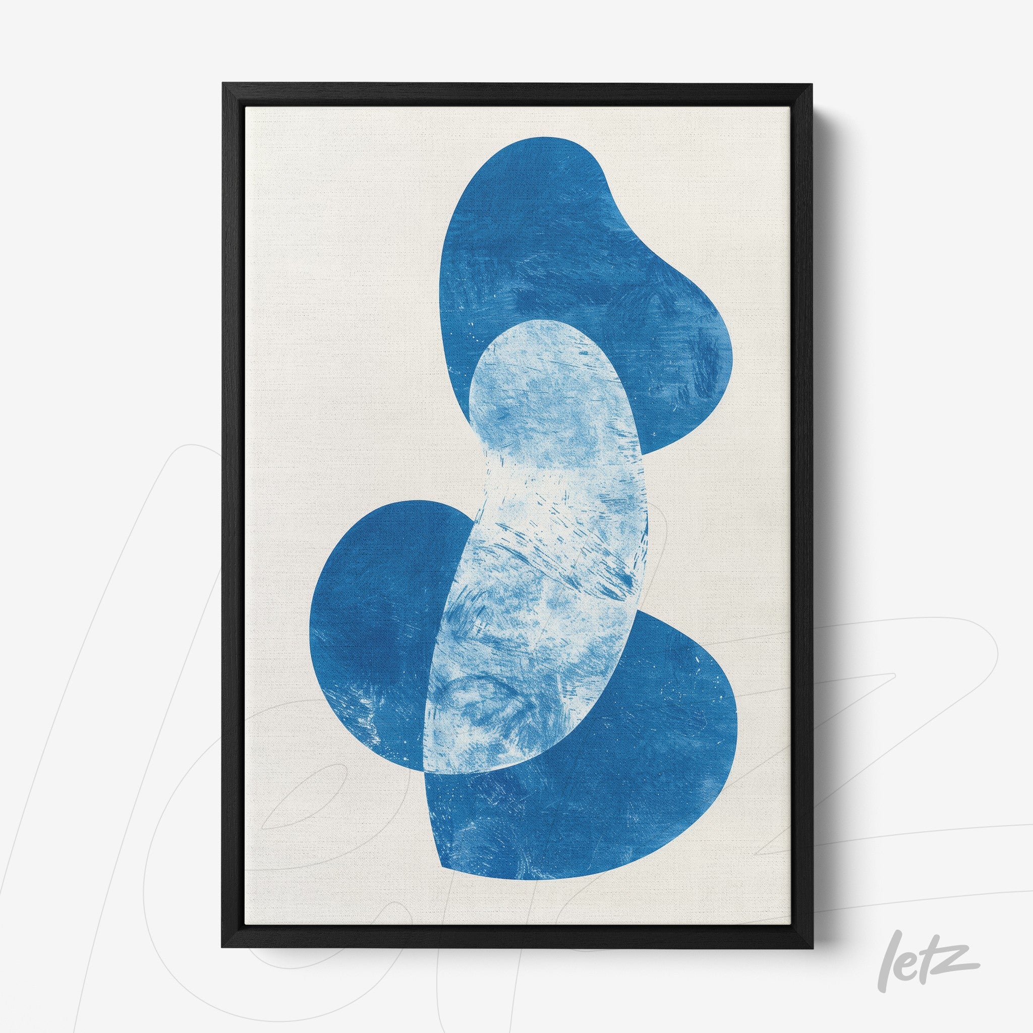 framed abstract art in blue on light background with black frame