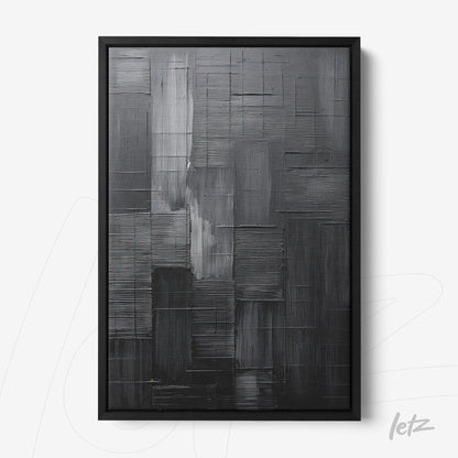 abstract wall art in shades of black and gray within a black frame