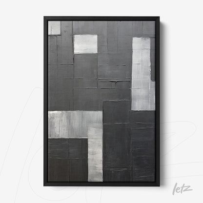 abstract wall art featuring textures in black and gray tones, framed in black