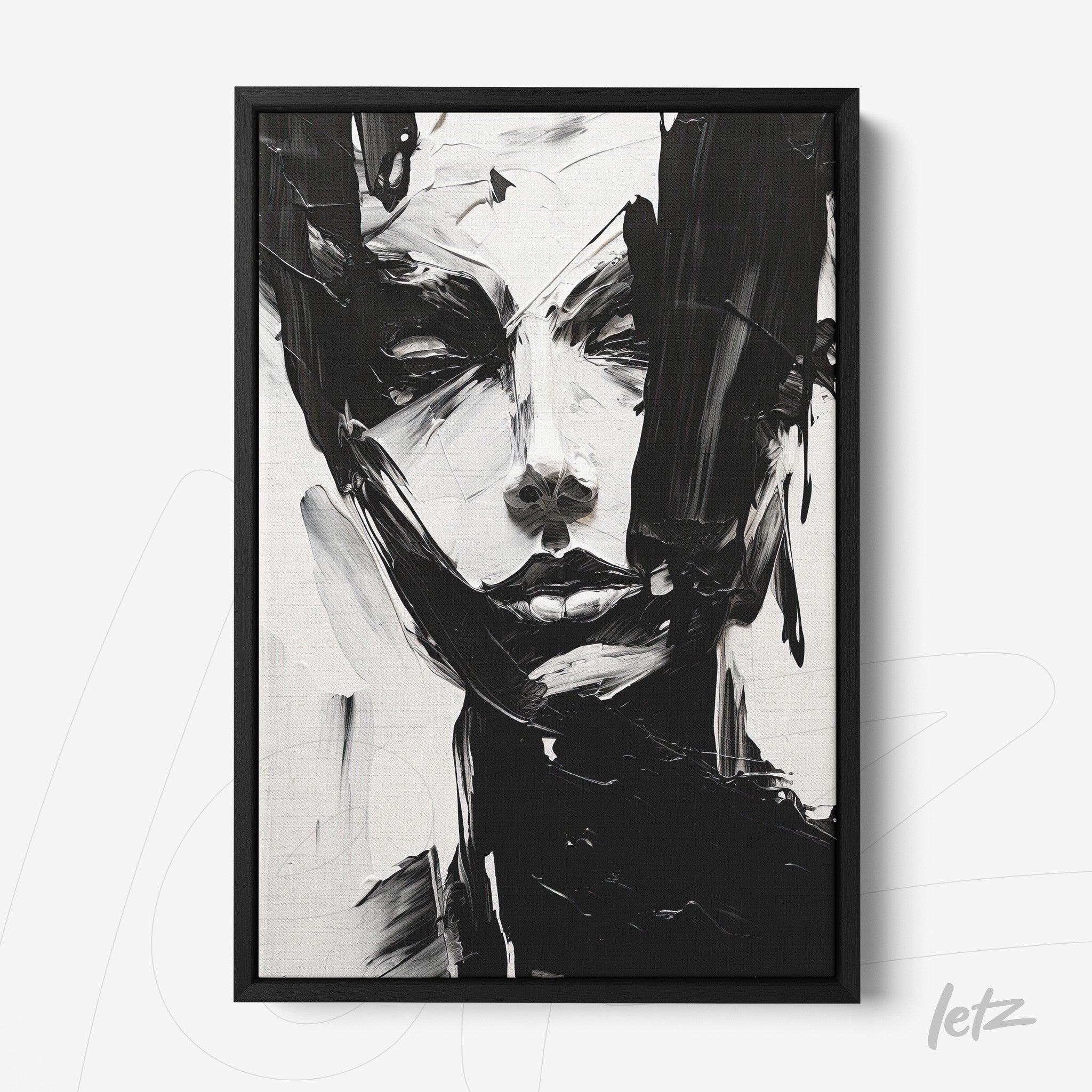 framed artwork featuring an abstract portrayal of a female face in black and white with a black frame