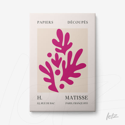 framed wall art featuring modern stylized shapes in pink on a cream background with a white frame