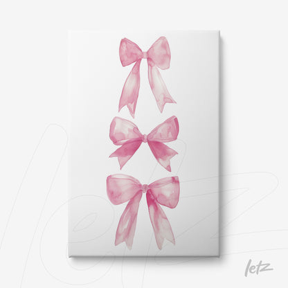canvas print featuring three watercolor pink bows on a white background