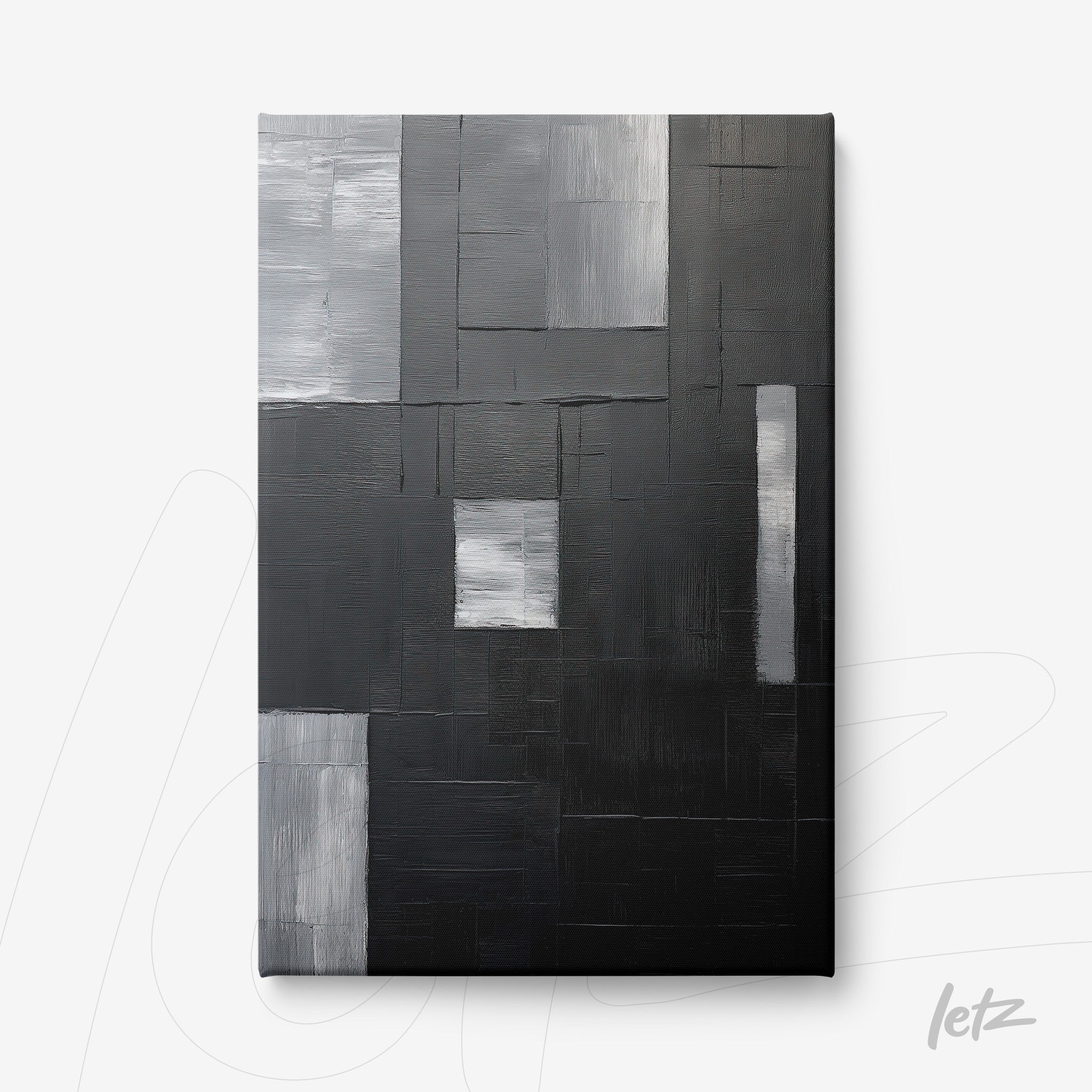 canvas artwork featuring abstract design in shades of black, gray, and white with overlapping textures