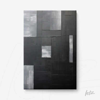 canvas artwork featuring abstract design in shades of black, gray, and white with overlapping textures