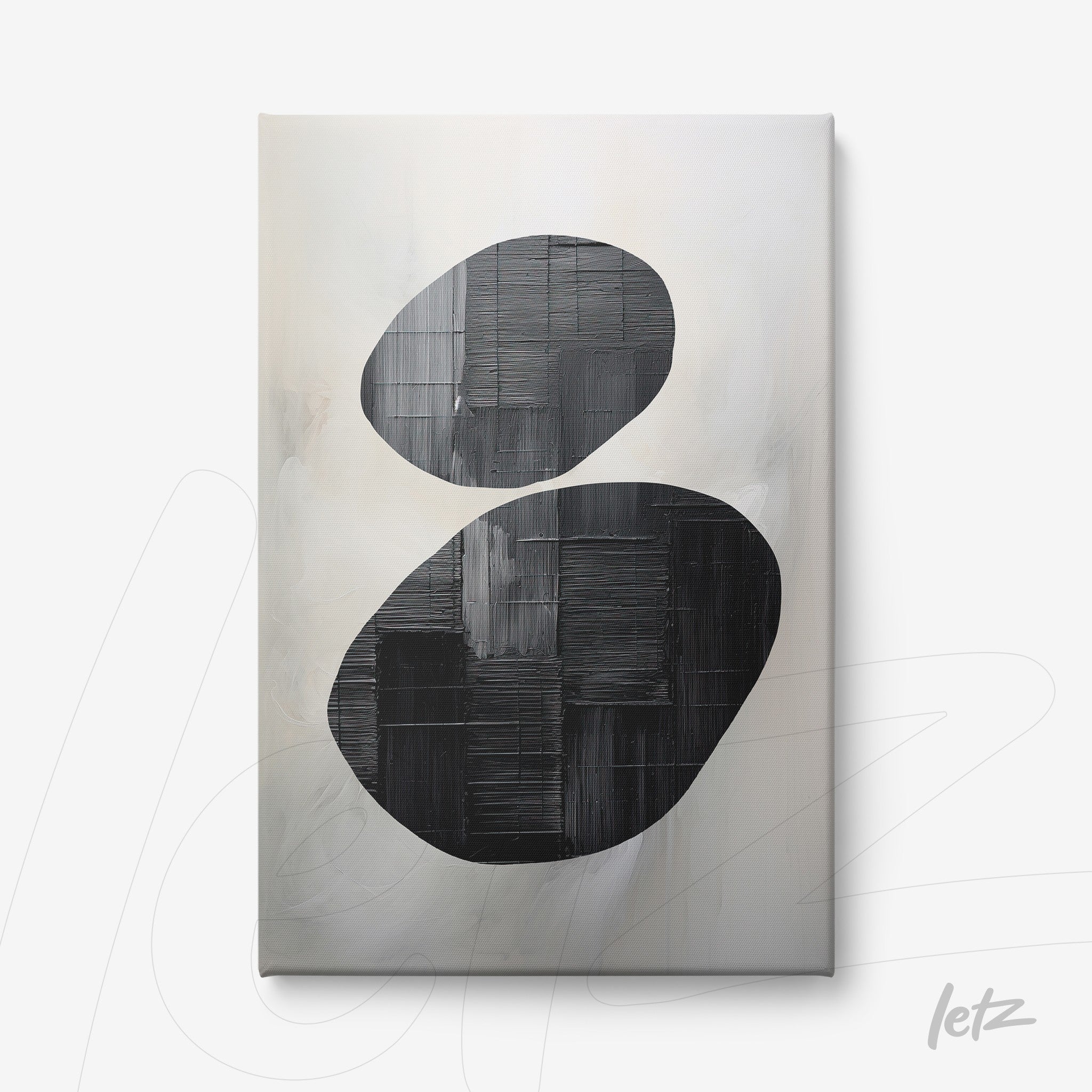 canvas artwork featuring abstract black shapes on a soft light background