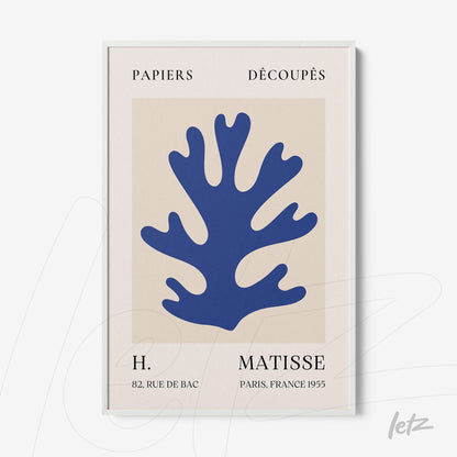 abstract wall art featuring blue cut-out plant shape on light background with white frame