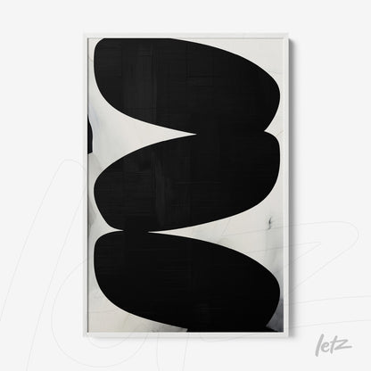 framed wall art featuring abstract black shapes on a light background