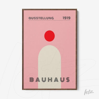 minimalist bauhaus poster in pink and red tones with dark wood frame