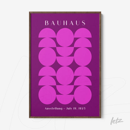 poster featuring geometric art in shades of pink and purple, with a dark wood frame