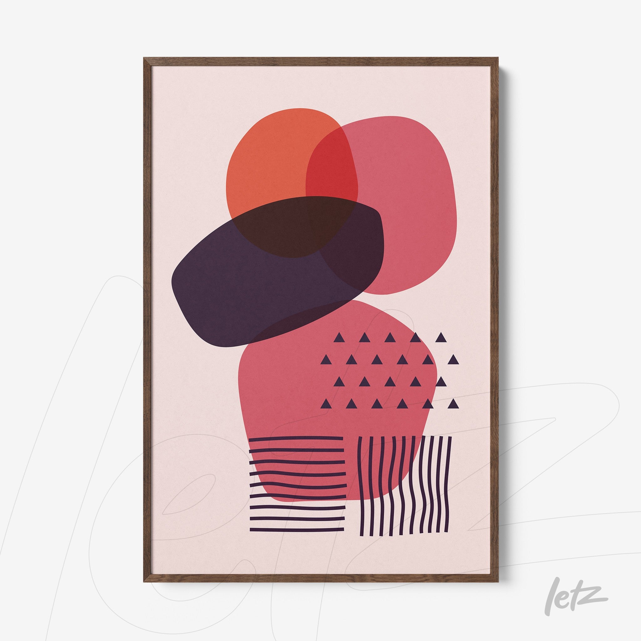 abstract poster with overlapping geometric shapes in red and purple with dark wood frame